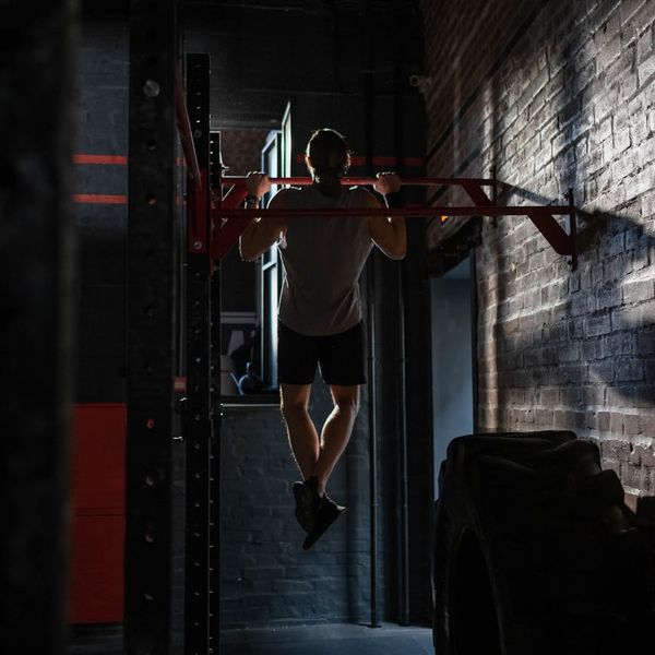 Close up of a man's hands gripping a pull-up bar