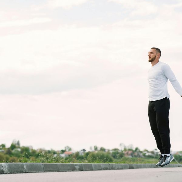 Shadow of a man jumping rope in a sunlit room